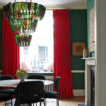 Dining room with chandelier made from reused green bottles