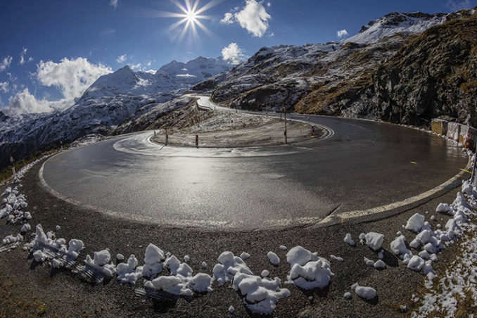 hairpin bend on a snowy mountain pass in the Alps
