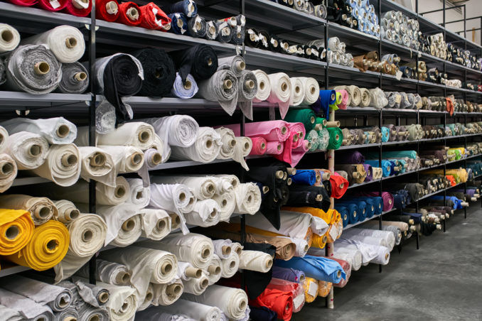 Fabric warehouse with many multicoloured textile rolls