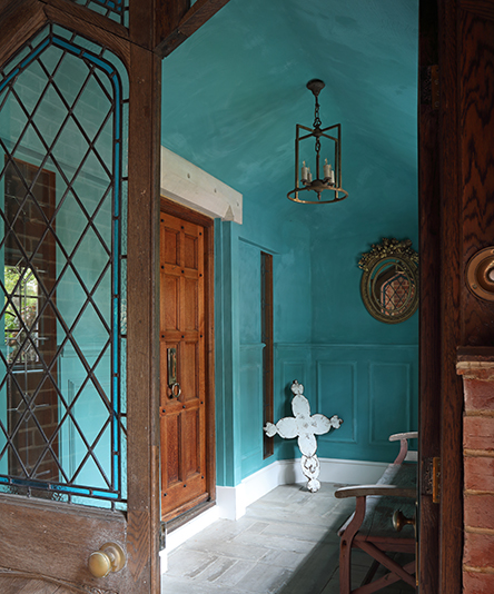 Beautiful entrance hallway of a Surrey home renovation with cool blue painted walls designed by Ana Engelhorn