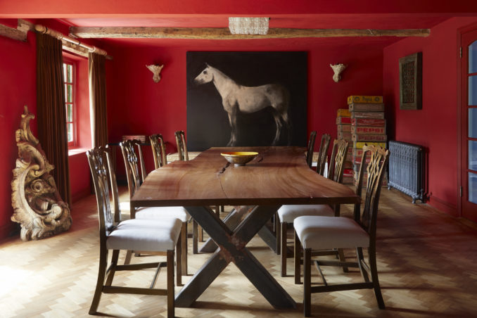 An amazing red dining room to show how interior design with colour can transform a traditional country house. This perfect home interior design is finished off with an amazing painting of a horse by Miquel Macaya.