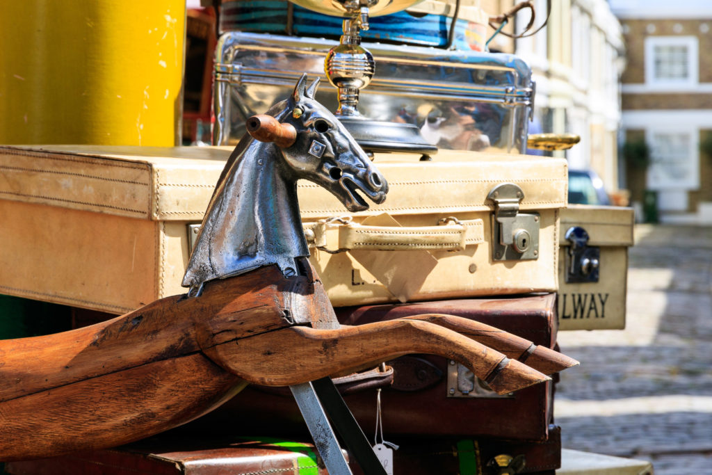 Image of lots being sold in one of London's many antique markets, a great place to find interior design treasure