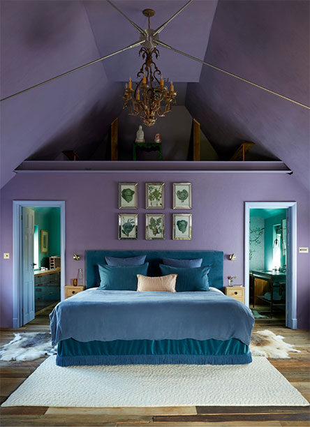 luxury bedroom with mauve coloured walls and ceiling, and dual entry on either side of a king-size bed leading to an en-suite.